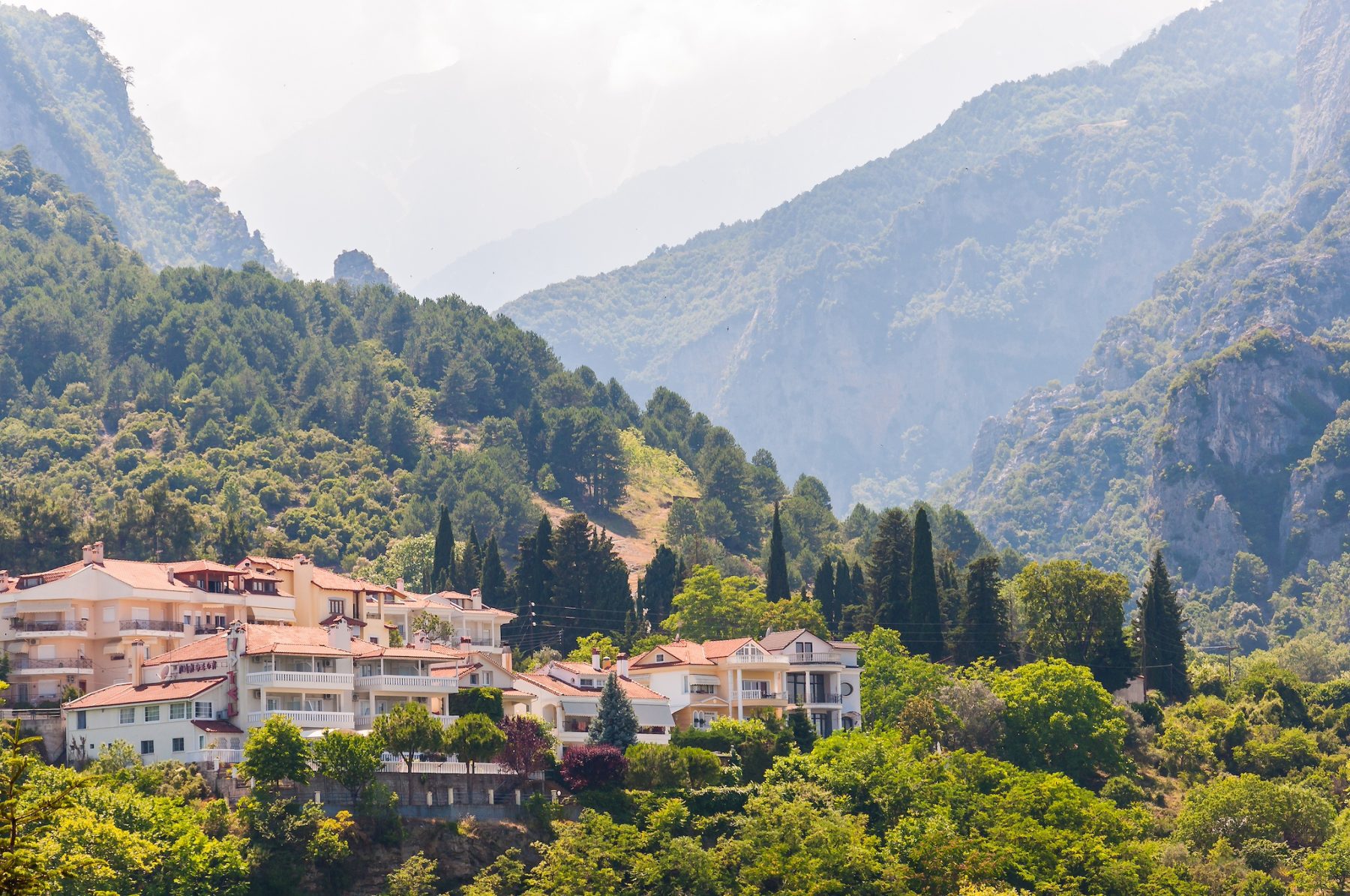 Litochoro, Greece - June 16, 2013: Popular touristic panoramic viewpoint on Mount Olympus from below from Litochoro town with its cozy hotels, apartments, scenic cityscape views and forest surroundings