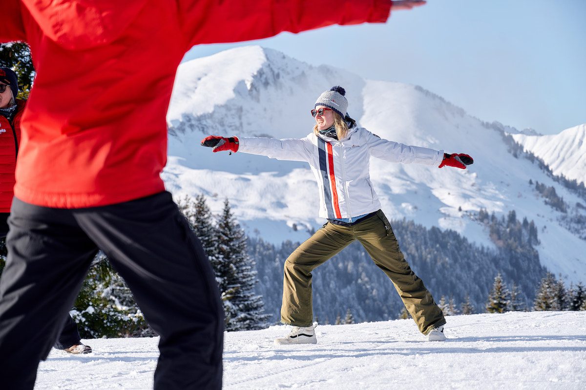 Twee personen tijdens een Pilates-sessie die onderdeel uitmaakt van één van de snowshoe hikes in Châtel en Les Gets.